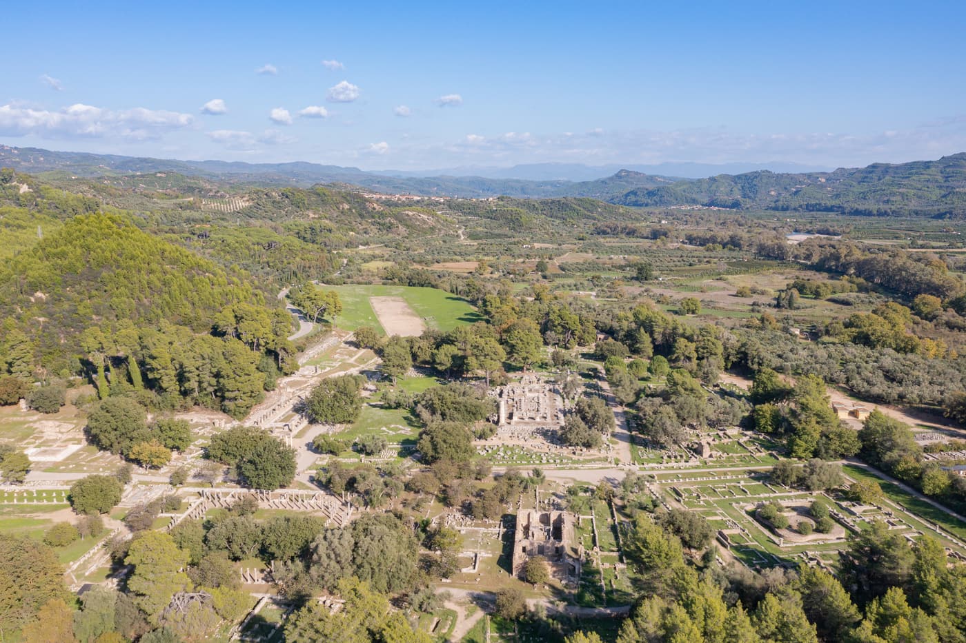 Aerial view of the archaeological site of Ancient Olympia in its green valley