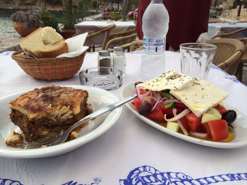 Moussaka and a Greek salad on a taverna table