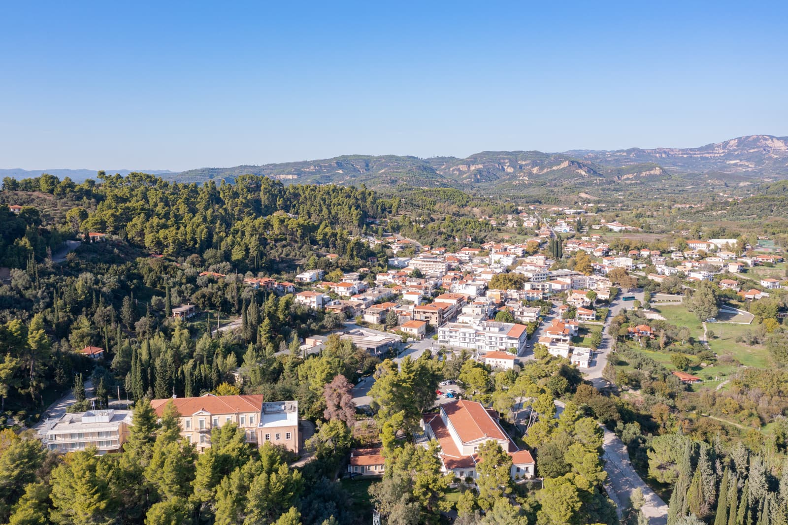 The village of Olympia among green hills, seen from the air